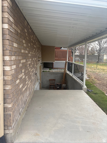 3918 Mapleleaf Way West Jordan, UT 84088 - Photo 11 of 12 View of patio / terrace featuring an attached carport