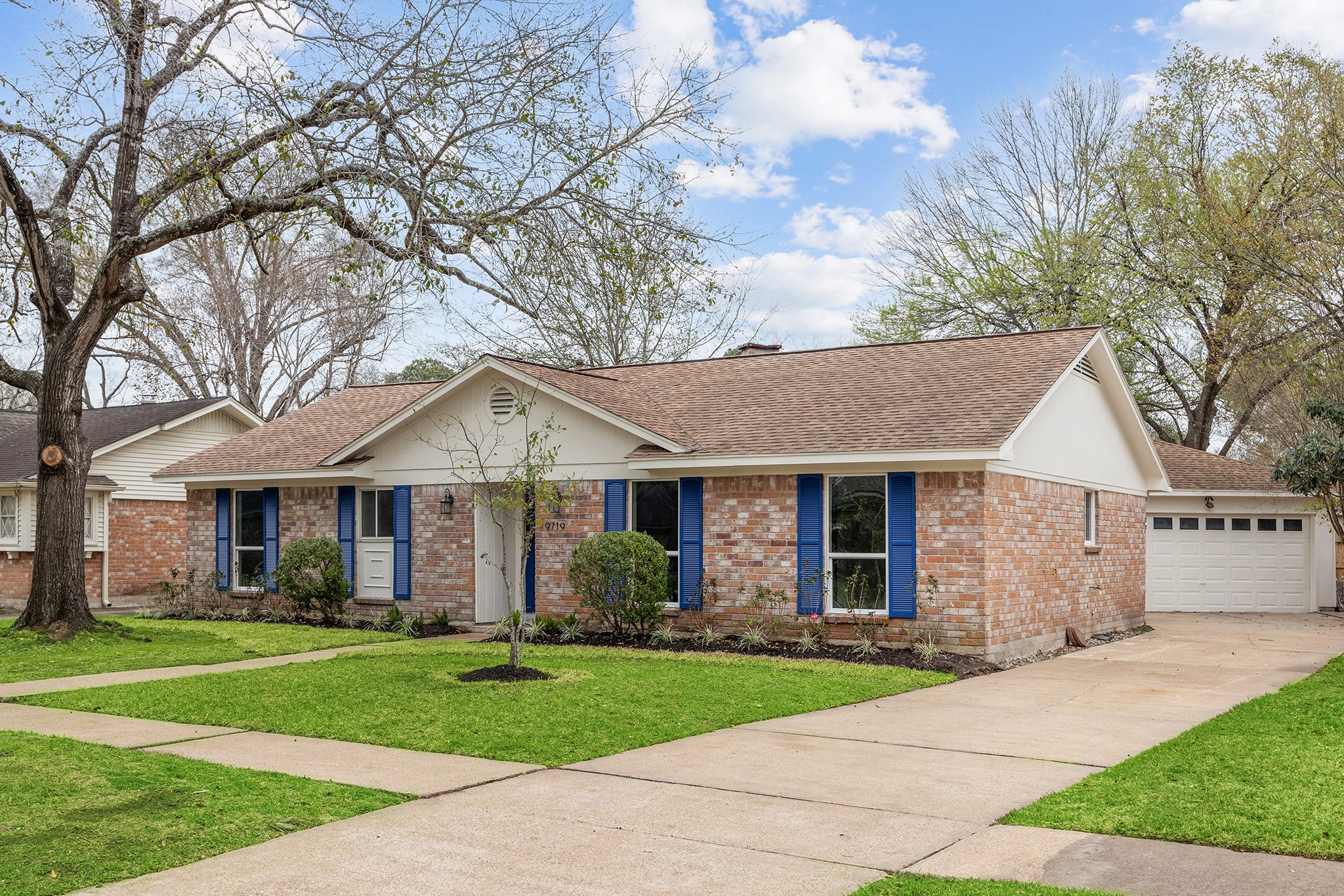 9719 Springmont Drive Houston, TX 77080 - Photo 3 of 32 Gorgeous, balanced traditional facade boasts a recent coat of paint and mature landscaping! Big deep front yard with recently poured concrete walkway!