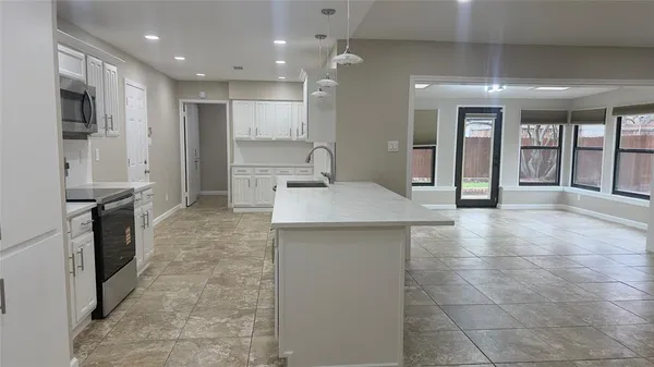 a kitchen with stainless steel appliances granite countertop a refrigerator and a sink