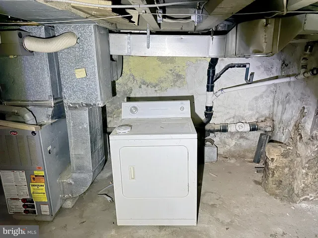 an empty room with wooden floor mirror and windows