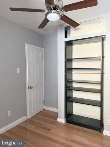 a view of hallway with wooden floor