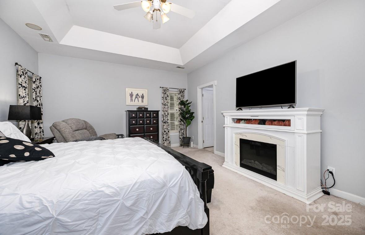6930 Reedy Creek Road Charlotte, NC 28215 - Photo 14 of 28 a bedroom with a bed and a flat screen tv