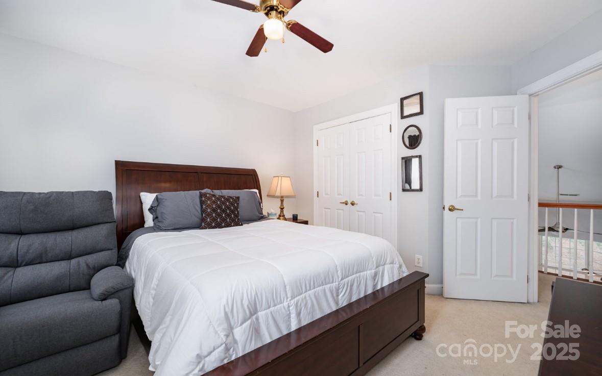 6930 Reedy Creek Road Charlotte, NC 28215 - Photo 20 of 28 a bedroom with a bed and a couch