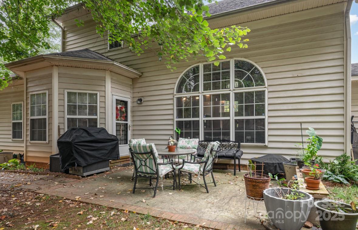 6930 Reedy Creek Road Charlotte, NC 28215 - Photo 22 of 28 a view of a patio with table and chairs and potted plants