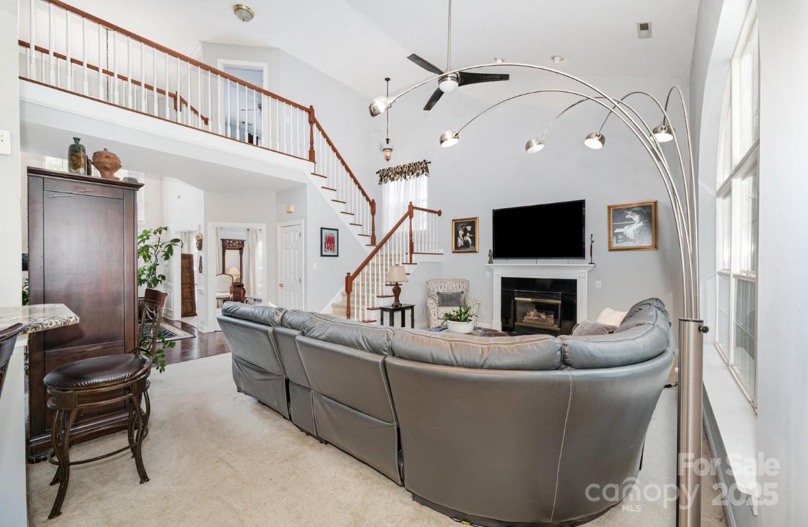 6930 Reedy Creek Road Charlotte, NC 28215 - Photo 28 of 28 a living room with furniture a flat screen tv and a fireplace