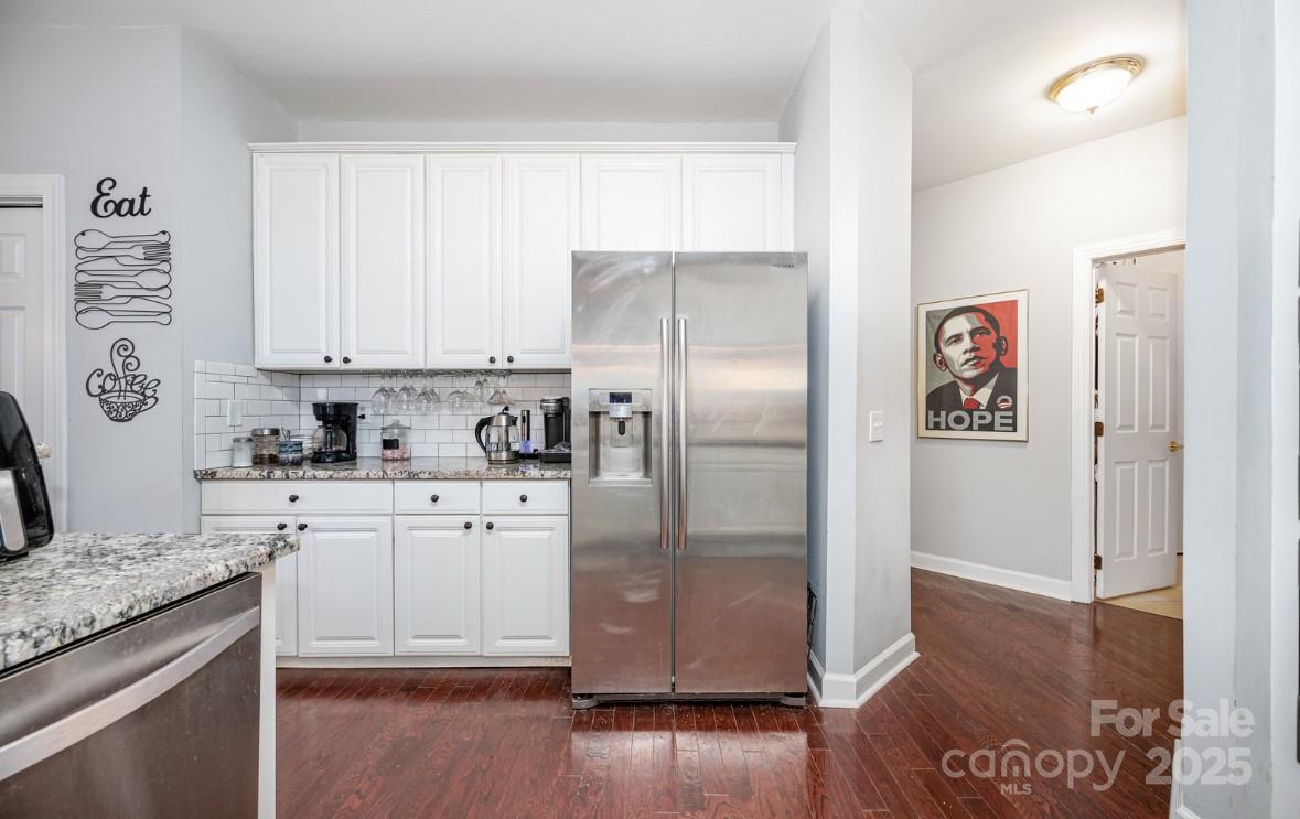 6930 Reedy Creek Road Charlotte, NC 28215 - Photo 7 of 28 a kitchen with stainless steel appliances granite countertop a refrigerator and a stove top oven