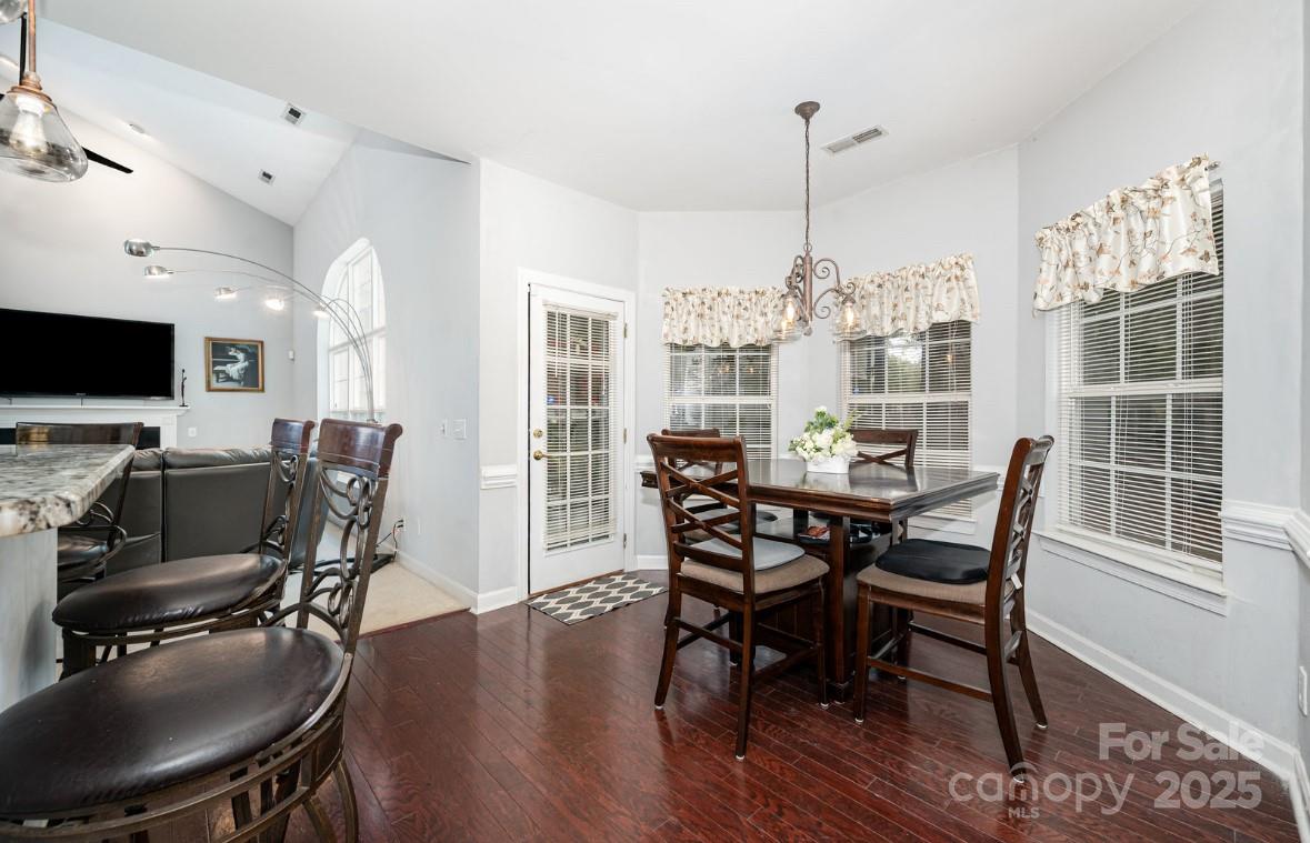 6930 Reedy Creek Road Charlotte, NC 28215 - Photo 8 of 28 a view of a dining room with furniture window and wooden floor