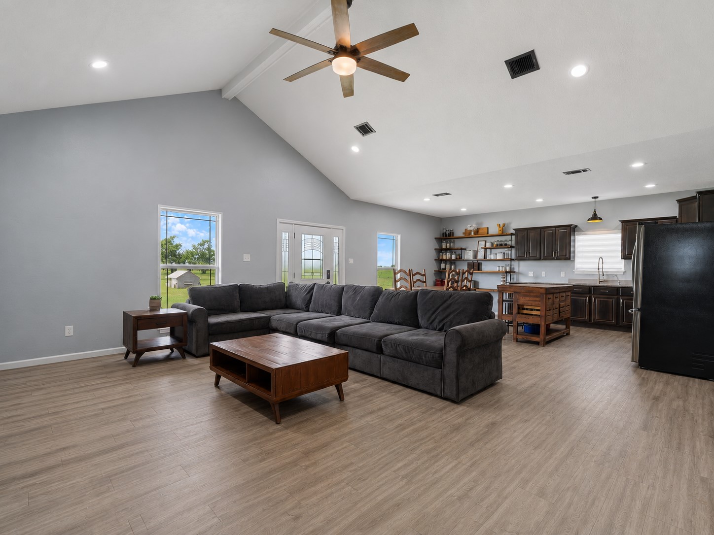 11301 South FM 441 Road El Campo, TX 77437 - Photo 32 of 32 Welcome to your new home! Soaring ceilings and LVP flooring. Spacious open floor plan perfect for entertaining. Walls of windows allow natural light to stream in and provide panoramic views of the acreage.