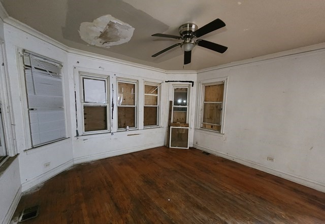 6716 South Bell Avenue Chicago, IL 60636 - Photo 4 of 10 a view of an empty room with a window and wooden floor