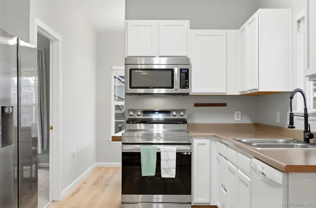 a kitchen with stainless steel appliances granite countertop a stove and a microwave