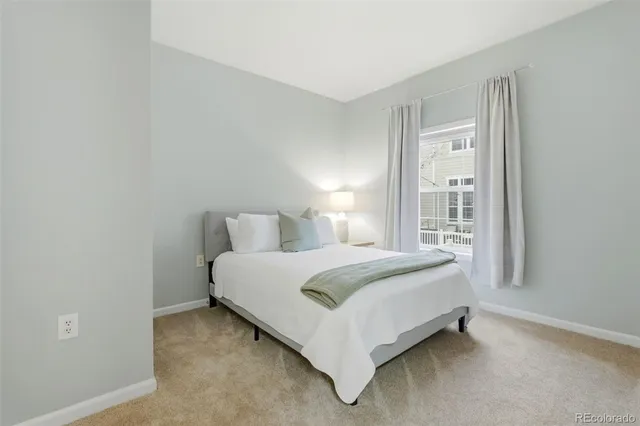 a bed sitting in a bedroom next to a window