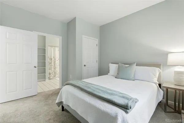 a bedroom with a bed and a night lamp