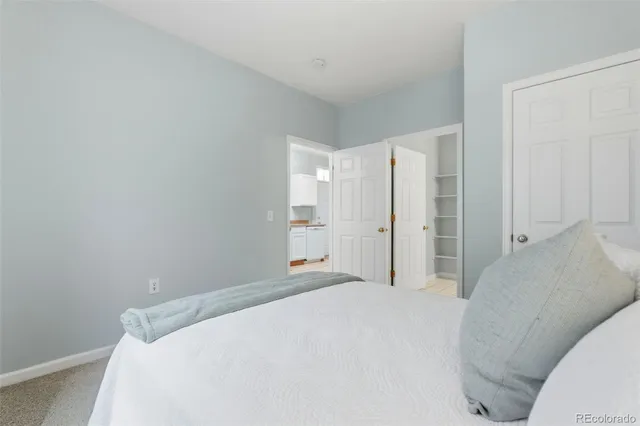 a bedroom with a bed and cabinets