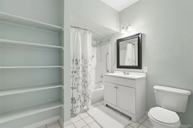 a bathroom with a toilet sink and shower