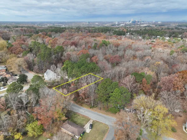an aerial view of house with yard and mountain view in back