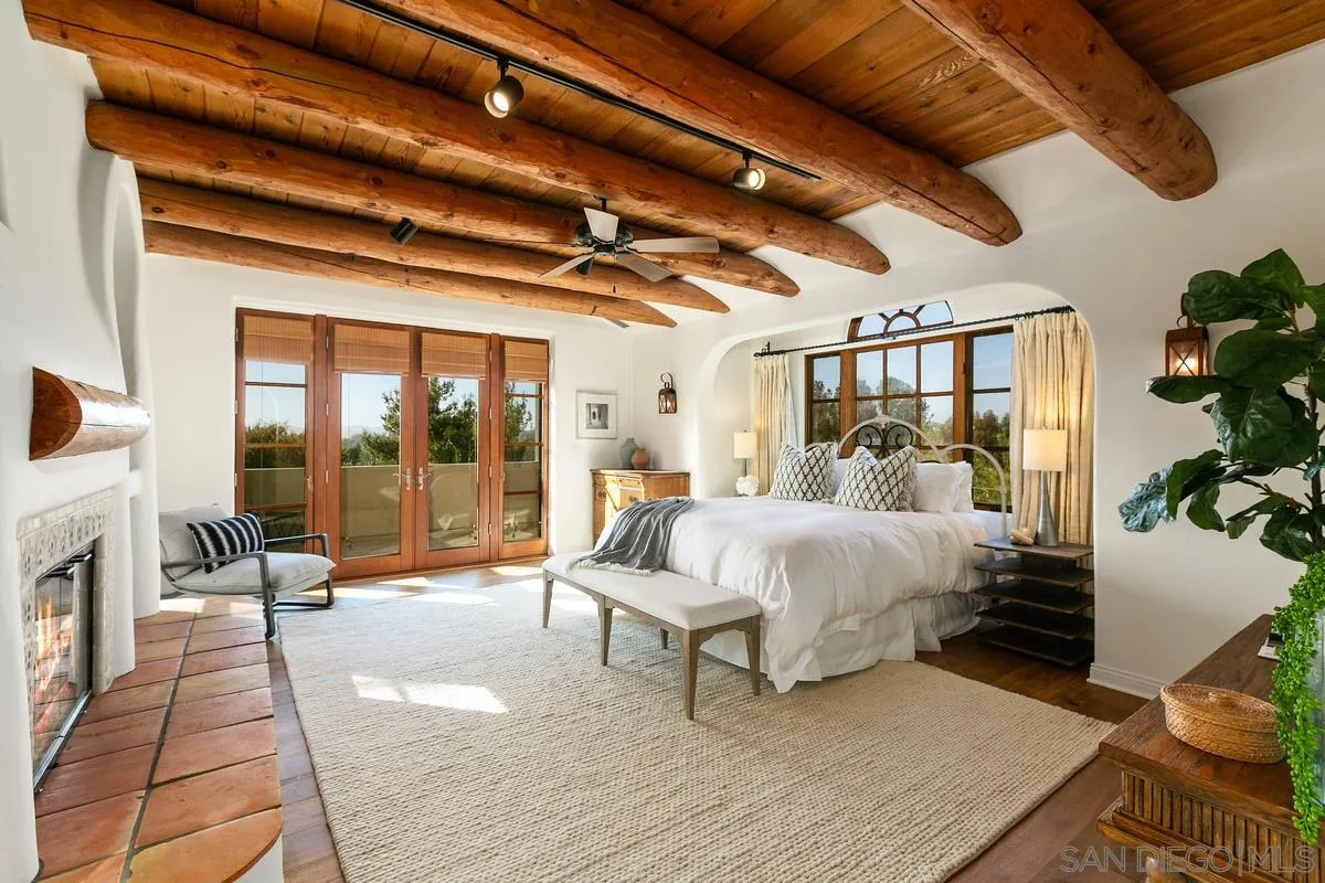 16309 Orchard Bend Road Poway, CA 92064 - Photo 23 of 66 a spacious bedroom with a bed and a large window