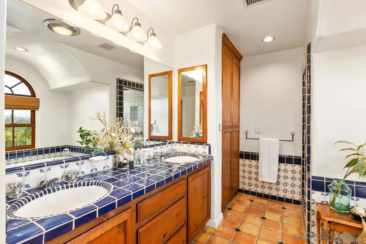 16309 Orchard Bend Road Poway, CA 92064 - Photo 26 of 66 a spacious bathroom with a granite countertop sink and a mirror