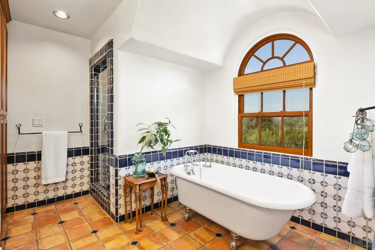 16309 Orchard Bend Road Poway, CA 92064 - Photo 27 of 66 a bathroom with a bathtub and a window
