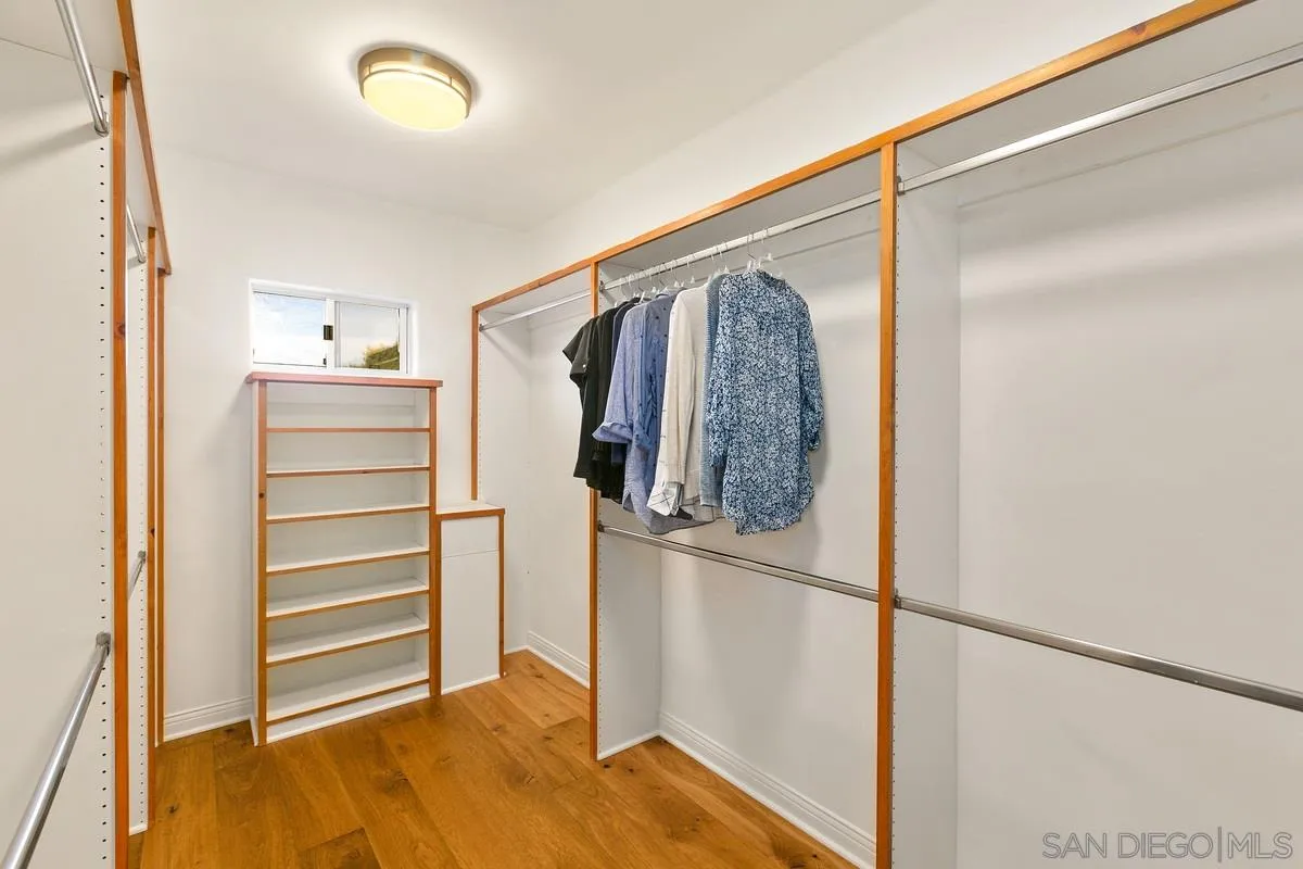 16309 Orchard Bend Road Poway, CA 92064 - Photo 29 of 66 a view of walk in closet with clothes and shoes