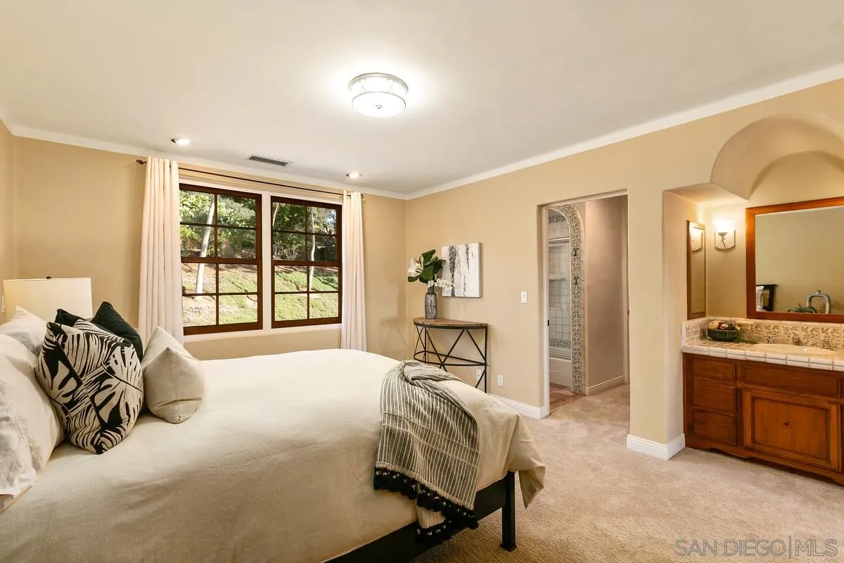 16309 Orchard Bend Road Poway, CA 92064 - Photo 40 of 66 a spacious bedroom with a bed and a large window