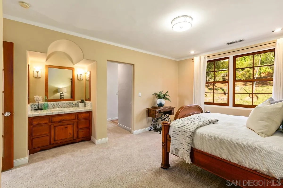16309 Orchard Bend Road Poway, CA 92064 - Photo 43 of 66 a spacious bedroom with a bed and a dresser