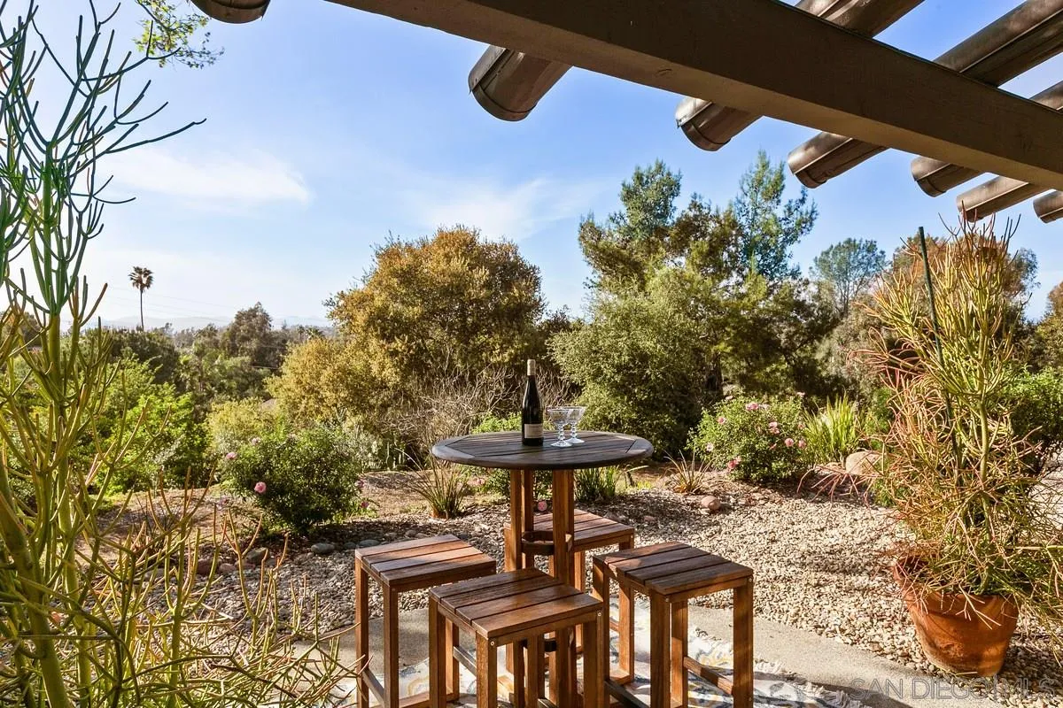 16309 Orchard Bend Road Poway, CA 92064 - Photo 57 of 66 a view of a patio with table and chairs and potted plants