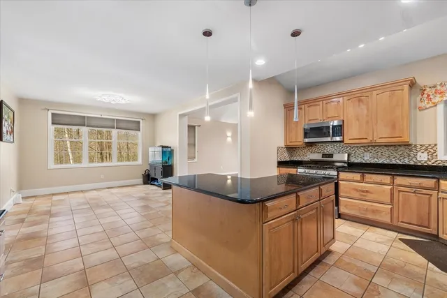 a kitchen with stainless steel appliances granite countertop a sink and a stove