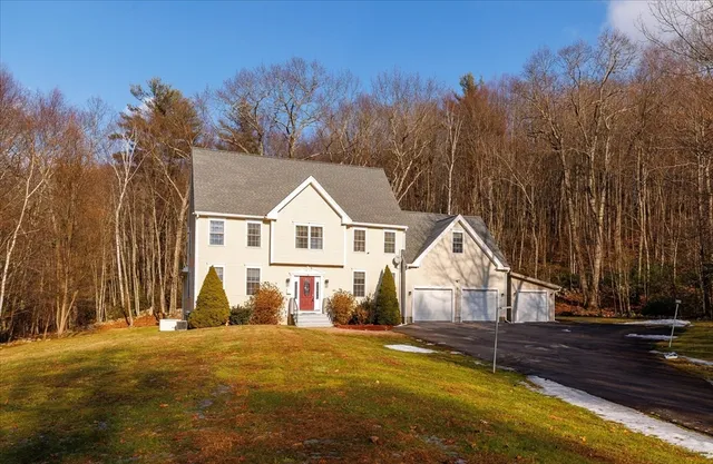 a view of a house with backyard and trees