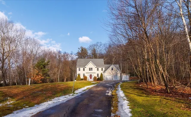 a view of a house with snow on the road