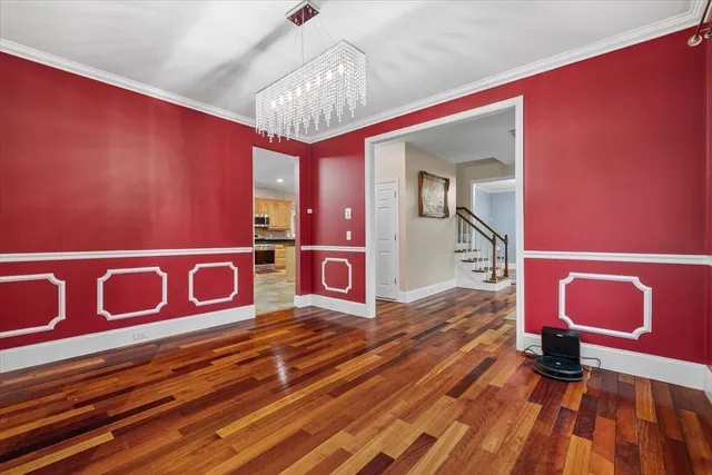a view of a room with furniture and chandelier