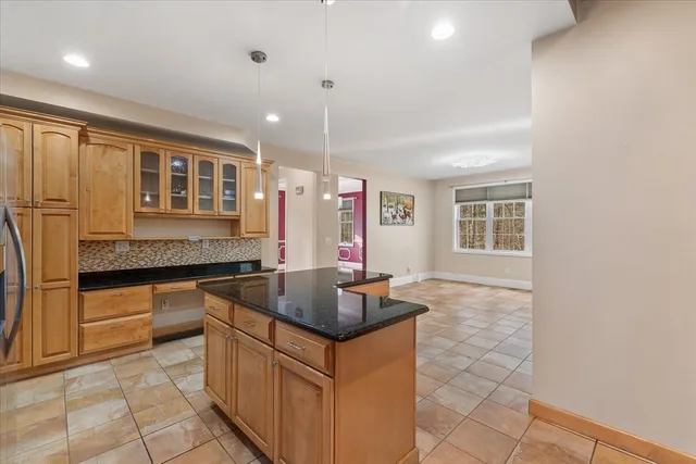 a kitchen with granite countertop a sink and cabinets