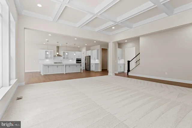 a large white room with kitchen appliances and cabinets