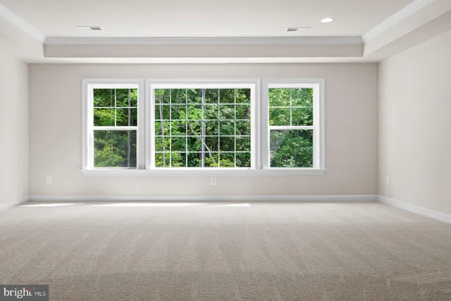 a view of empty room with large windows