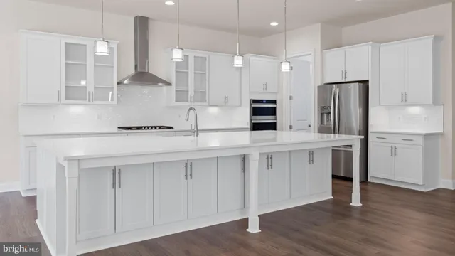 a kitchen with stainless steel appliances sink refrigerator and microwave