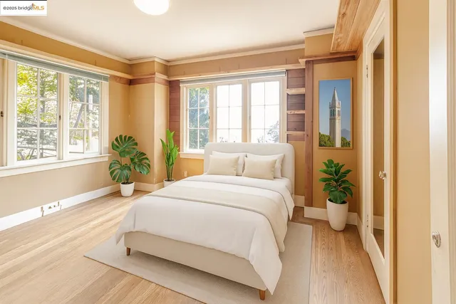 a view of a livingroom with wooden floor and furniture