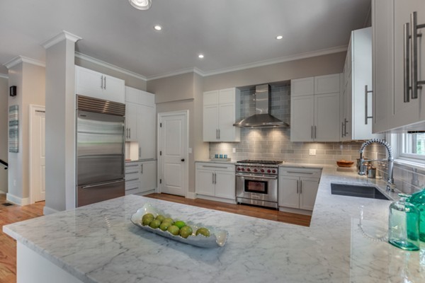 66 Perry Street, Unit 2 Brookline, MA 02446 - Photo 2 of 15 a kitchen with stainless steel appliances granite countertop a stove refrigerator and a sink