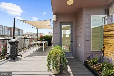 a view of a patio with a table and chairs and potted plants