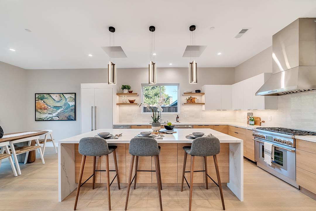 10872 West Estates Drive Cupertino, CA 95014 - Photo 24 of 58 a kitchen with stainless steel appliances kitchen island granite countertop a stove a sink a dining table and chairs