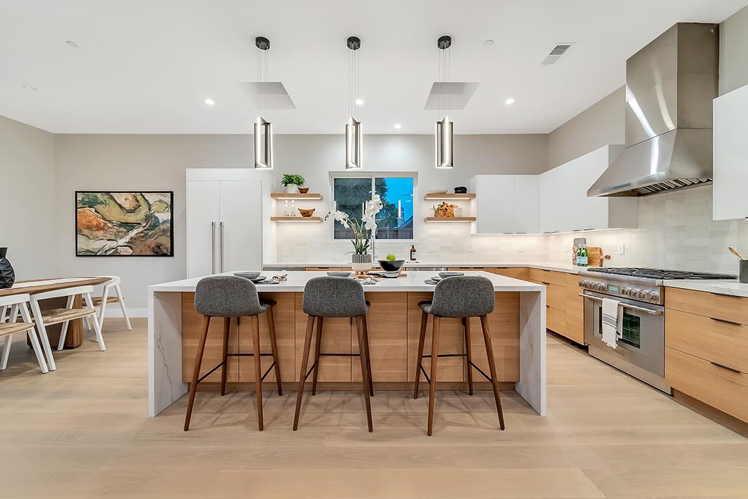 10872 West Estates Drive Cupertino, CA 95014 - Photo 46 of 58 a kitchen with stainless steel appliances kitchen island granite countertop a table and chairs in it