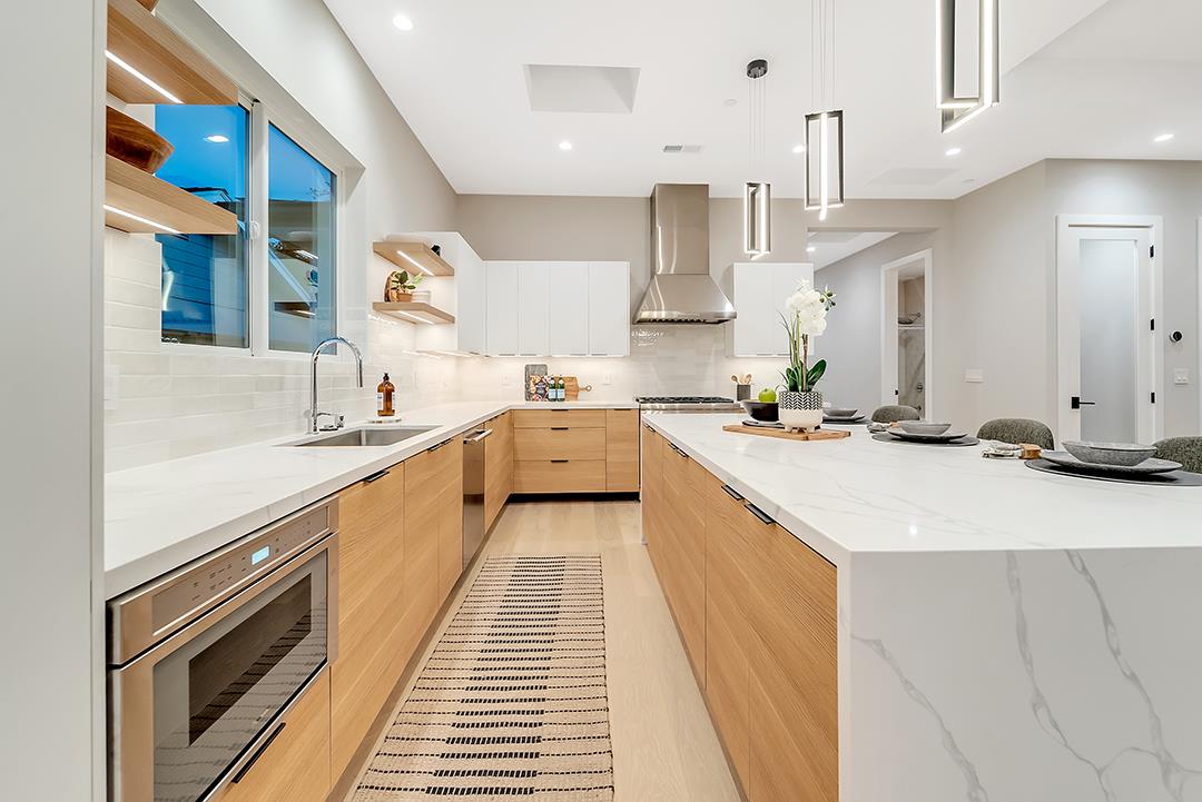 10872 West Estates Drive Cupertino, CA 95014 - Photo 52 of 58 a large kitchen with stainless steel appliances kitchen island granite countertop a sink and cabinets