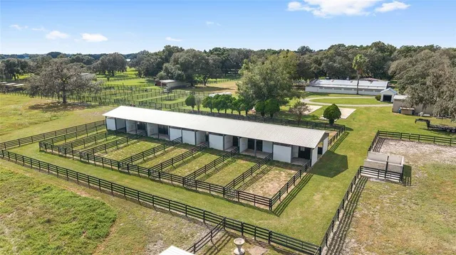 a large kitchen with kitchen island a island a stove a table and a dining table