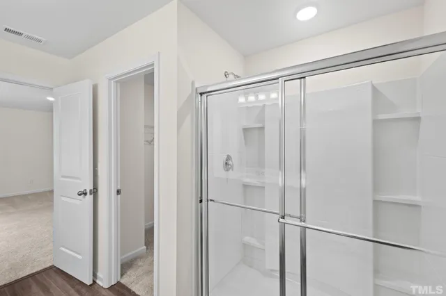 a bathroom with a glass shower door