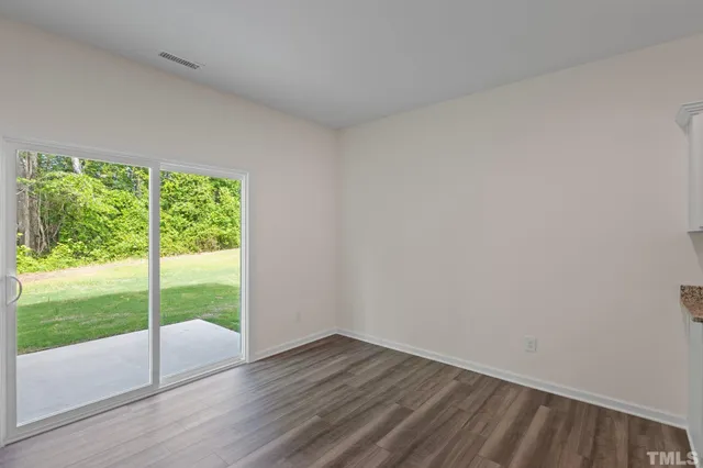 a view of an empty room and wooden floor