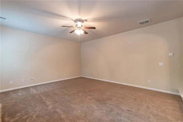 a kitchen with stainless steel appliances granite countertop a stove a sink dishwasher a refrigerator white cabinets and wooden floor