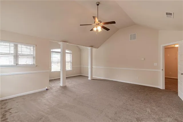 a view of a room with a ceiling fan