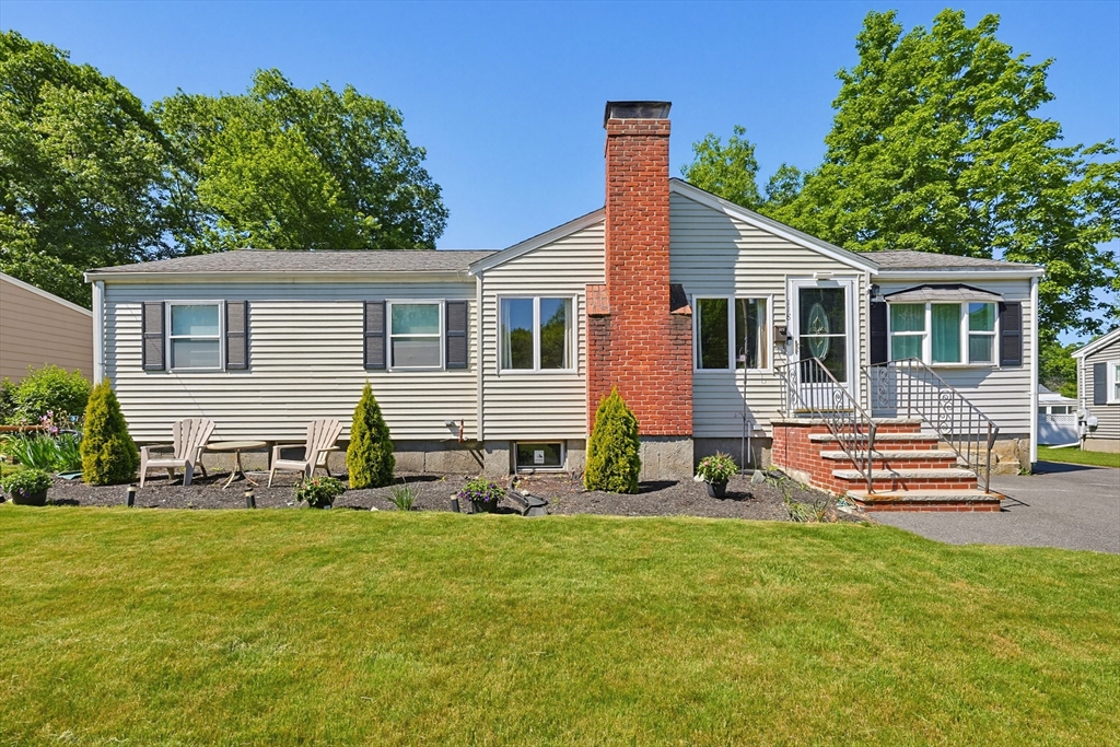 118 Spruce Road Norwood, MA 02062 - Photo 23 of 39 a front view of a house with a garden