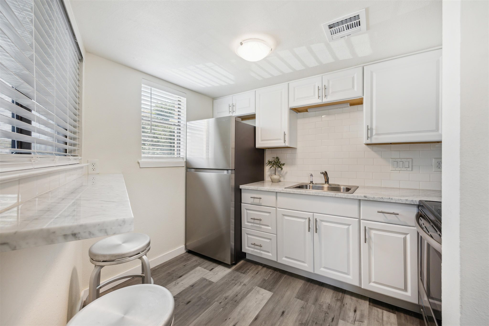 2500 Burleson Road, Unit 200 Austin, TX 78741 - Photo 6 of 12 a kitchen with stainless steel appliances a refrigerator sink and microwave
