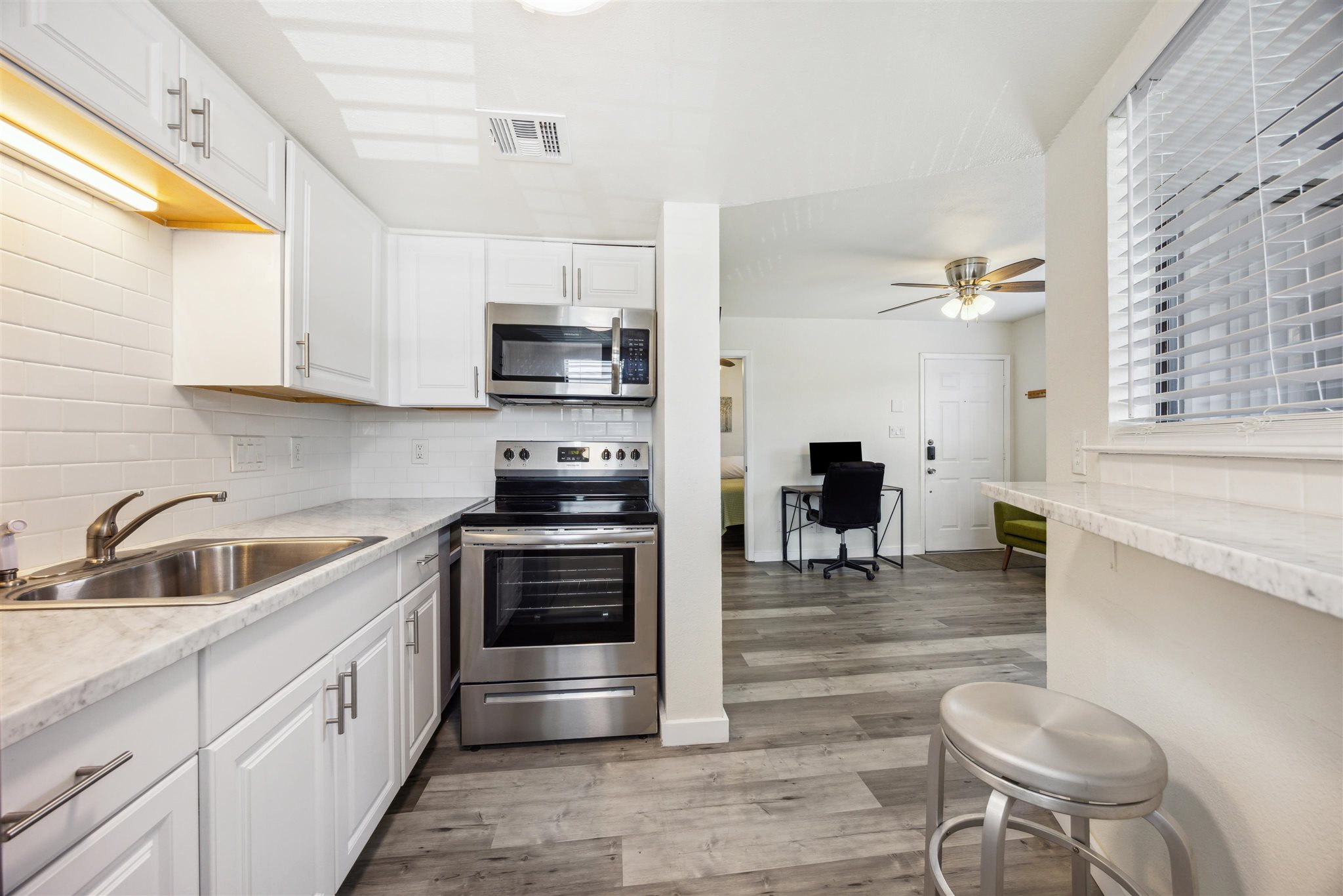 2500 Burleson Road, Unit 200 Austin, TX 78741 - Photo 7 of 12 a kitchen with granite countertop a stove and a sink