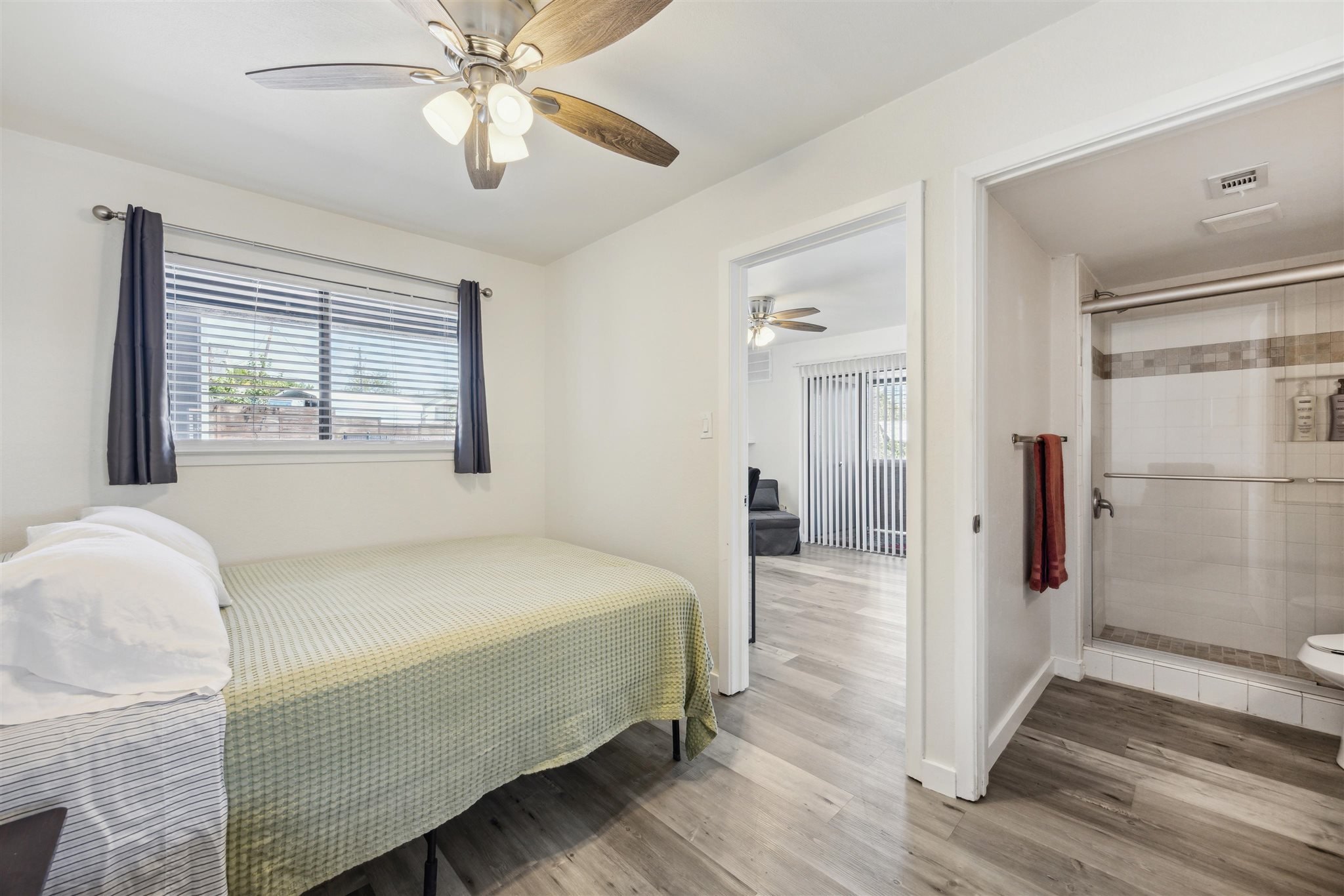 2500 Burleson Road, Unit 200 Austin, TX 78741 - Photo 9 of 12 a bedroom with a bed and a chandelier fan