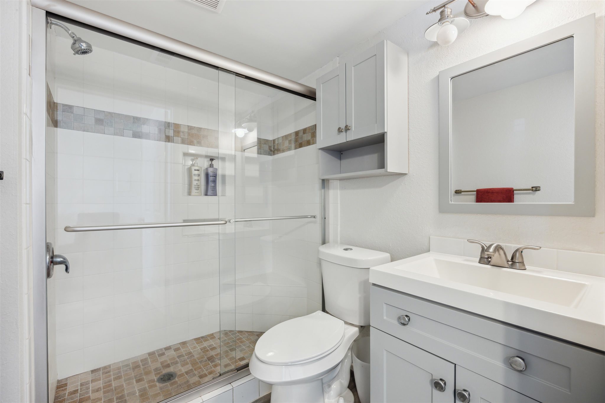 2500 Burleson Road, Unit 200 Austin, TX 78741 - Photo 10 of 12 a bathroom with a toilet sink vanity and mirror